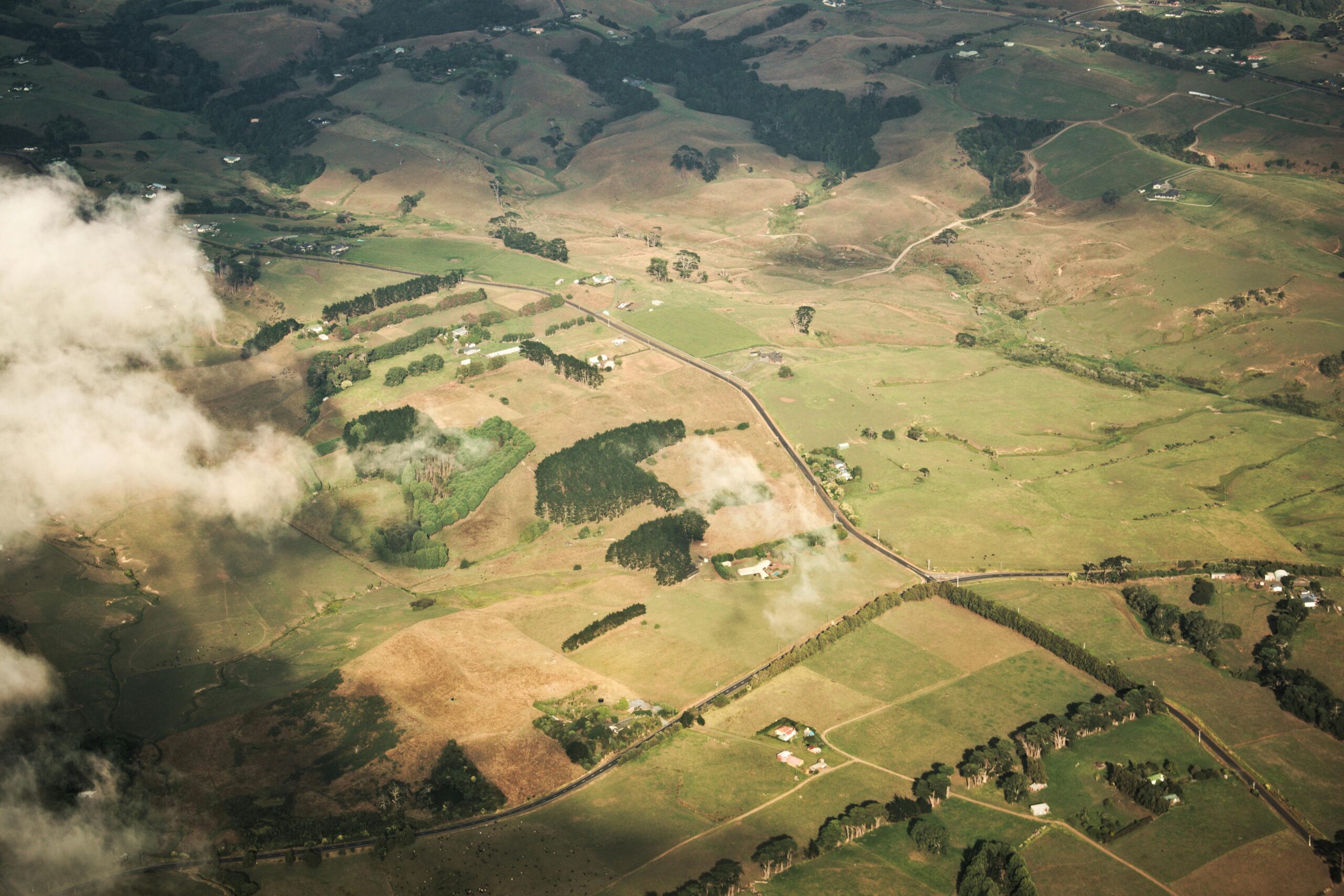 A breathtaking aerial view of a picturesque countryside landscape with scattered clouds.